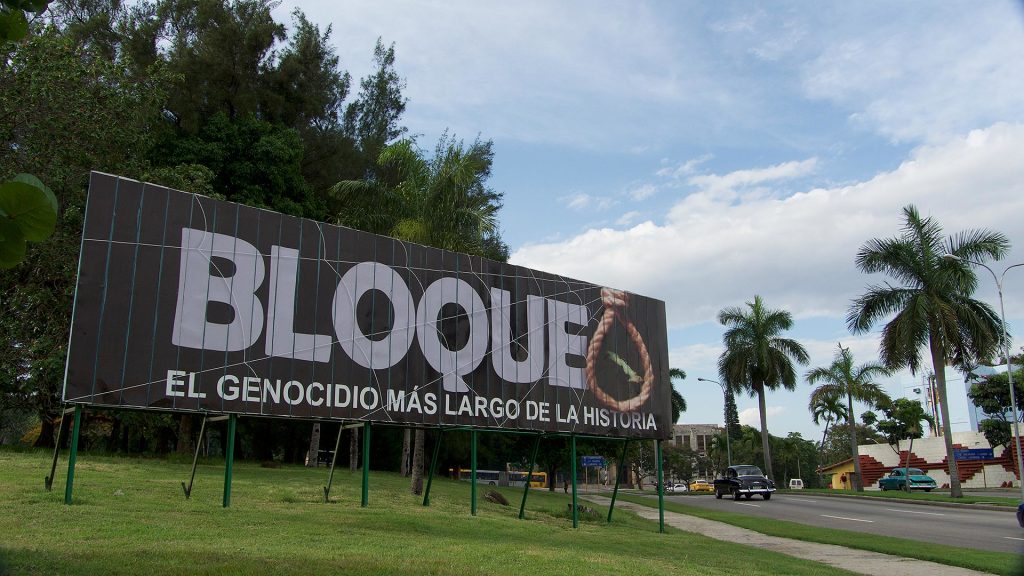 Billboard that says, "Bloque el genocidio más largo de la historia," in Havana, Cuba.